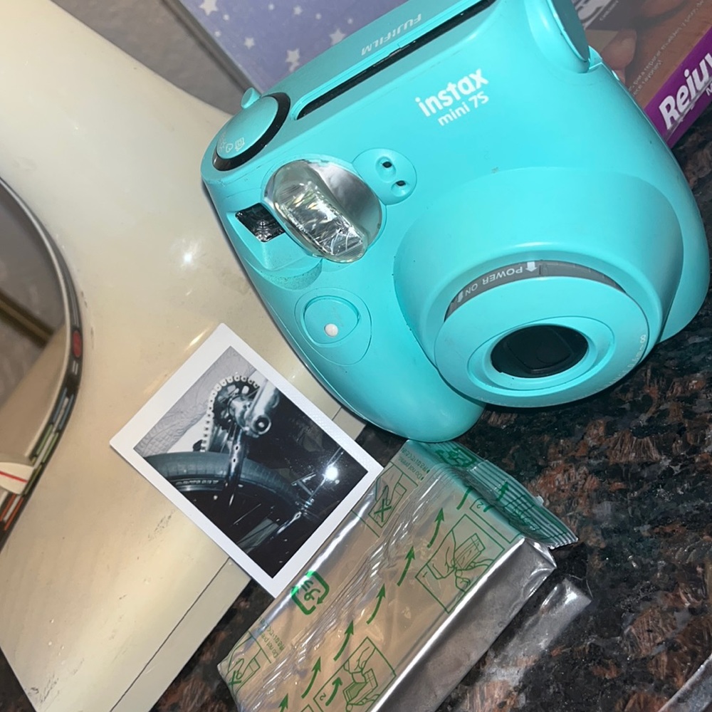 Polaroid camera made by Fujifilm called the Instax mini 7s